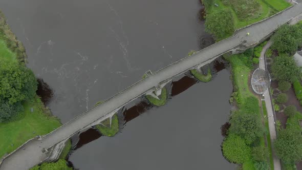 Slow motion, birds eye view of Stirling Old Bridge in Scotland while flying down. alt