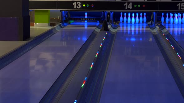 Bowling game. A bowling ball traveling down the lane and knocks down pins