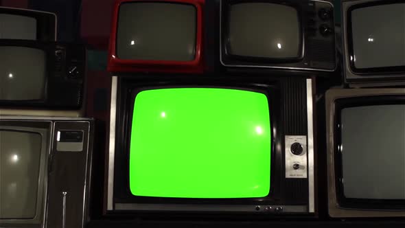 Vintage TV Green Screen Among Many Retro TVs. alt