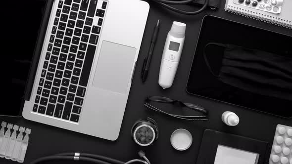 Doctor Desktop Concept. Various Medical Tools and Accessories Placed on Black Background Table alt