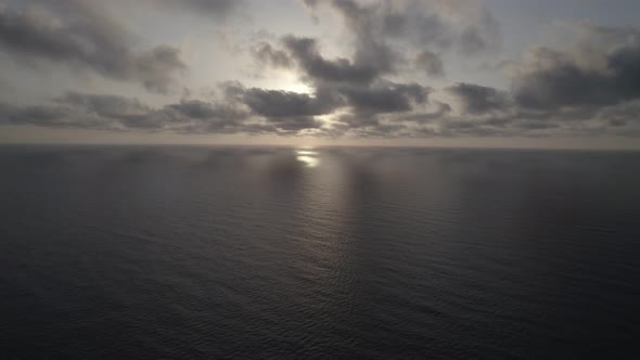 Sunrise over the sea. Epic view of the ocean and reflection of clouds and sun.