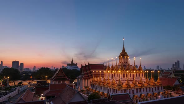 Loha Prasat or Iron Castle Monastery during morning, Bangkok, Thailand; night to day – time lapse