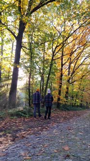 Couple Man and Woman Mid Age Walking in the Forest During Autumn Season in Nature Trekking with alt