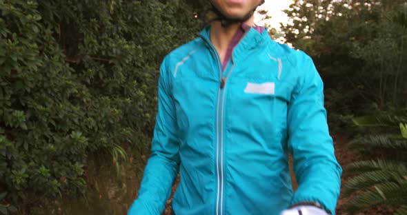 Portrait of female mountain biker with bike alt