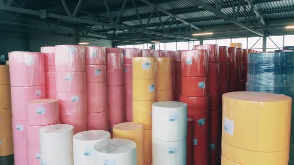 Many Colorful Paper Rolls Stored at a Big Warehouse alt