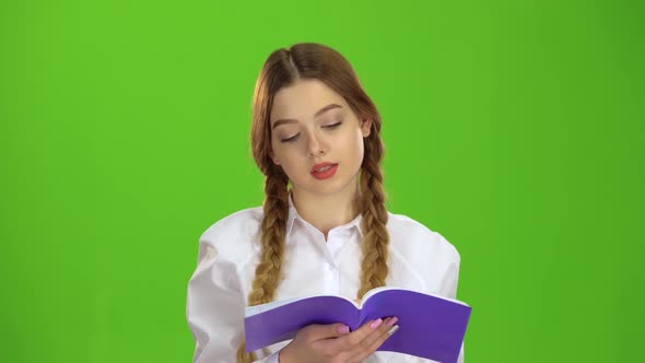 Student Scrolls Through the Notebook. Green Screen alt