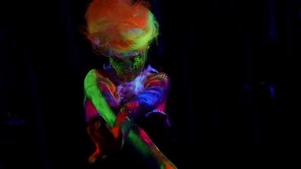 Fluorescent Makeup and Wig on Sexy Lady Glowing in Ultraviolet Light alt