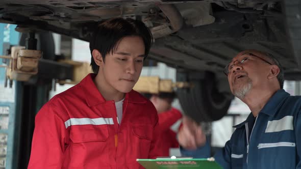 technician man car mechanic working in automotive garage to fix repair suspension auto car alt