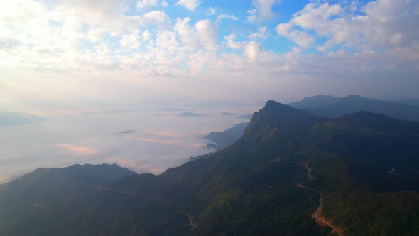 Aerial view from drone, Epic sunbeam over clouds mountains. 4K aerial shot on sunrise alt