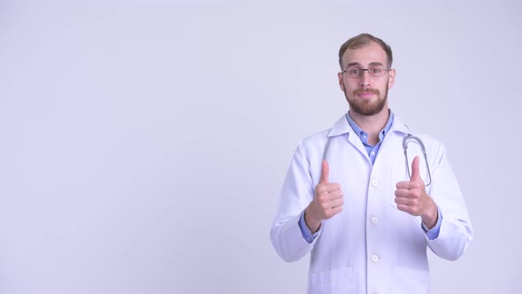 Happy Bearded Man Doctor Talking While Pointing Up