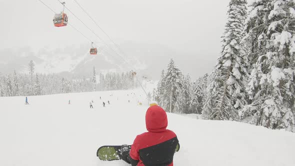 Skier Skiing and People on Snowboards Ride Down the Slope on Ski Resort in Mountains Winter alt