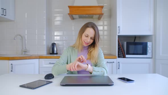 Using smart watches for communication. Cheerful female browse modern smart wristwatches in 4k alt