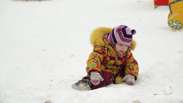 The child walks and plays near the kindergarten, outdoor.