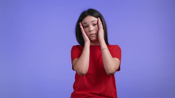 Bored Woman Portrait Her Head is Spinning Around on Violet Background alt