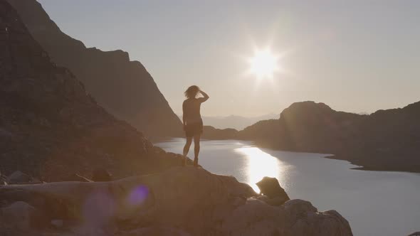 Adventurous Caucasian Adult Woman Hiking on Top of a Canadian Rocky Mountain alt