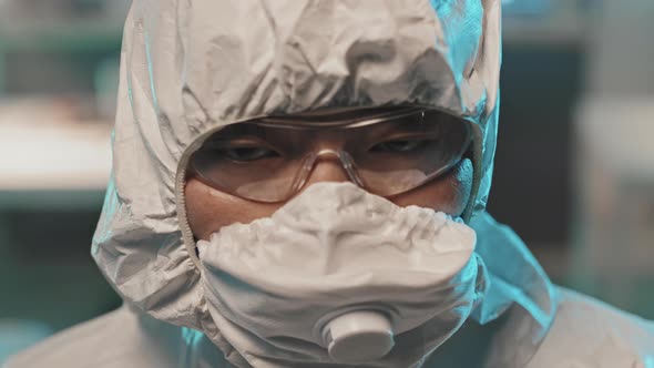 Portrait of Asian Female Lab Worker in Coveralls and Mask alt