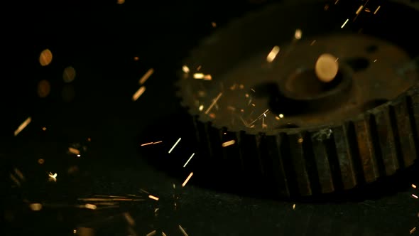 Sparks with gears in ultra slow motion 1500fps on a reflective surface - SPARKS w GEARS  alt