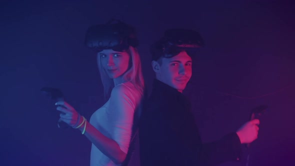 Two Gamers Young Man Girl Standing Cyber Neon Lighting Background Virtual Reality Glasses Their Head alt