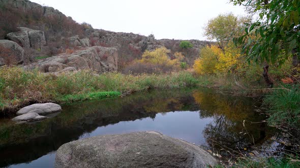 A Fast Clean Stream Runs Among Smooth Wet Stones Surrounded By Tall Dry Lumps alt