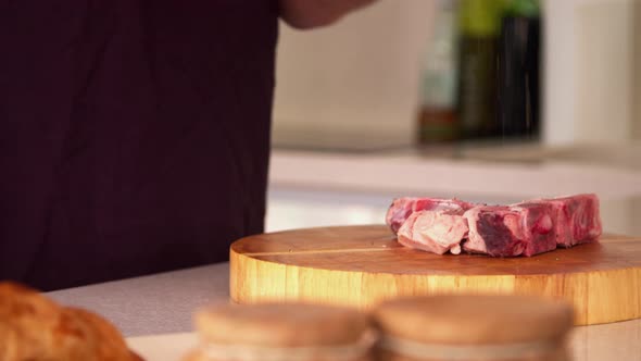 Man Preparing Steak in a Kitchen