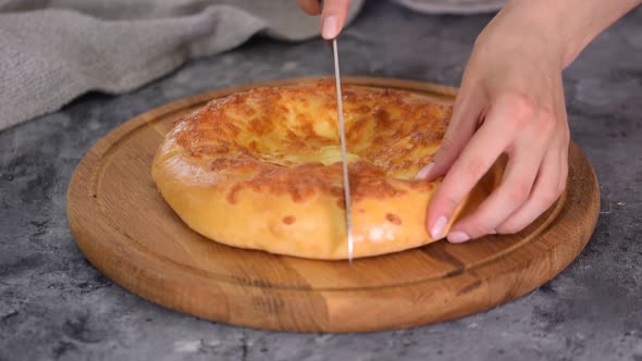 Freshly Baked Khachapuri with Cheese on a Wooden Table
