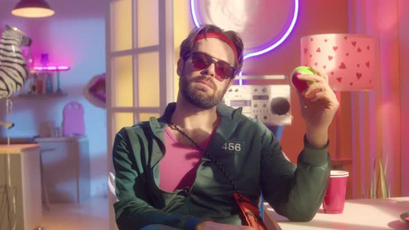 Portrait of Cool Guy in Trendy Outfit in Neon Studio alt