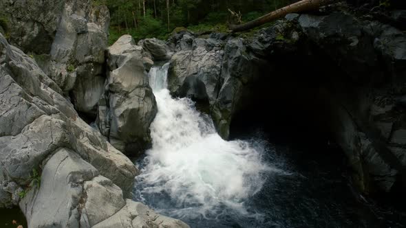Aerial Front Flip Cliff Jump Over Waterfall In Pacific Northwest alt