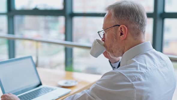 Businessman is checking presentation on a laptop  alt