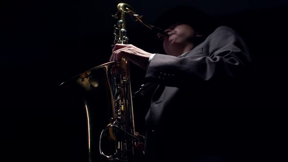 Artist Presses the Saxophone Valves with Fingers Closeup alt