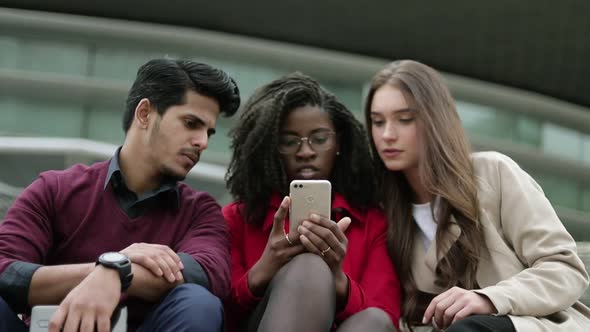Young People Searching on Phone Place To Go, Discussing alt