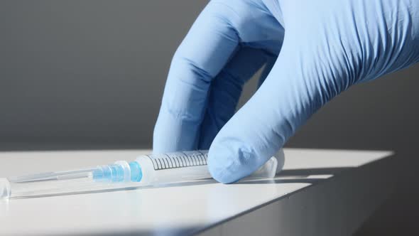 COVID19 Vaccine in Researcher Hands Doctor Puts on the Table Syringe and Bottle with Vaccine alt