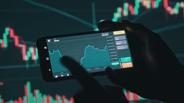 Investor Checking Bitcoin Chart on Smartphone Screen alt