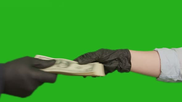 A hand in a rubber black glove reaches out and takes money, chroma key alt
