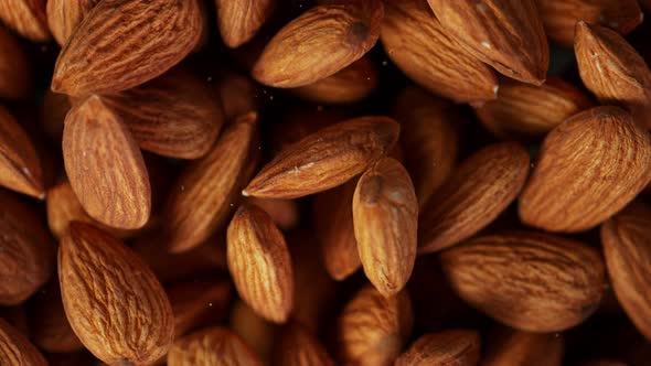 Super Slow Motion Detail Shot of Almonds Background at 1000 Fps alt
