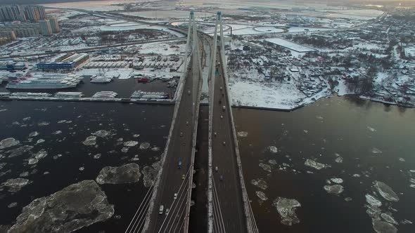 Aerial Footage of a Cablestayed Bridge Ice Moving Along the River alt