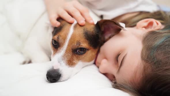 A Teenage Girl Sleeps with Her Dog in Bed alt