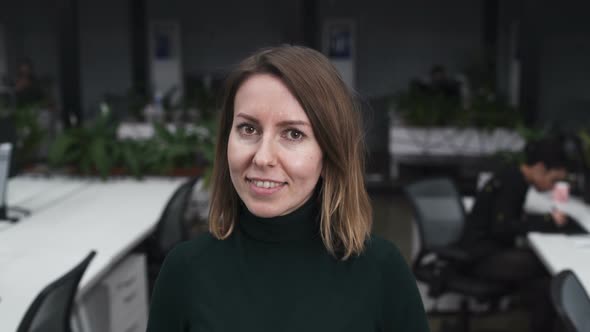 Happy Businesswoman Looking At Camera And Smiling