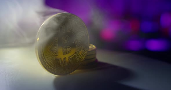 the Bitcoin Coin Rotates, Along in the Smoke. Close Up alt