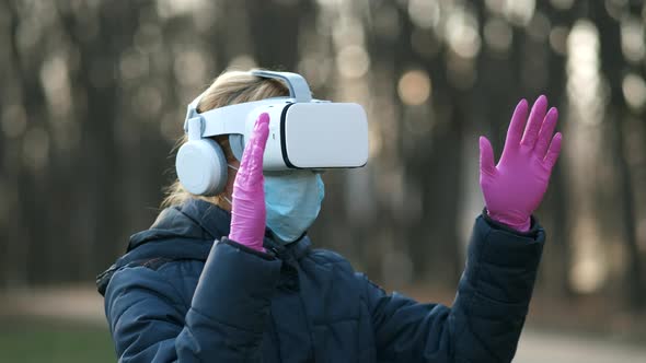 Girl in a medical mask and  virtual digital glasses the virtual reality. child using a VR-headset 