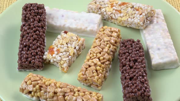 Muesli bars isolated on green plate.