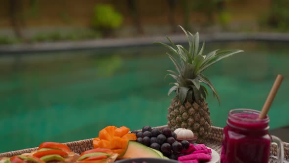 Closeup Shot of a Personal Breakfast on a Floating Table in a Private Swimming Pool. Tropical Beach alt