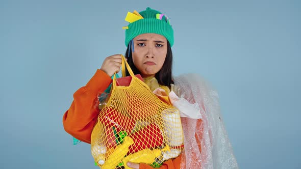 Asian woman holding package with plastic. 