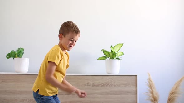 Boy in Yellow Tshirt Dancing at Home