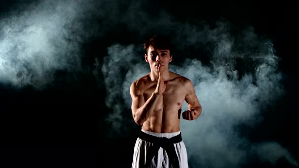 Karate or Taekwondo Man with a Naked Torso and a Black Belt, Smoke, Close Up alt
