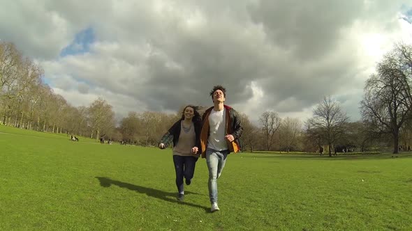 Couple running at park in London alt