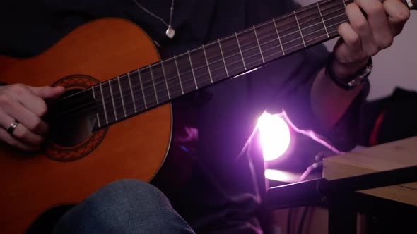 Man Plays Guitar Closeup Indoors