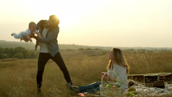 Happy Family Having Fun During Evening Picnic