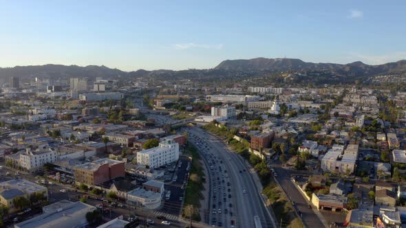 Cars and trucks on road traffic on highway to downtown LA. alt