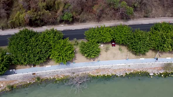 Aerial birdseye view of a pathway and a road along lake Chapala in Jalisco, Mexico alt