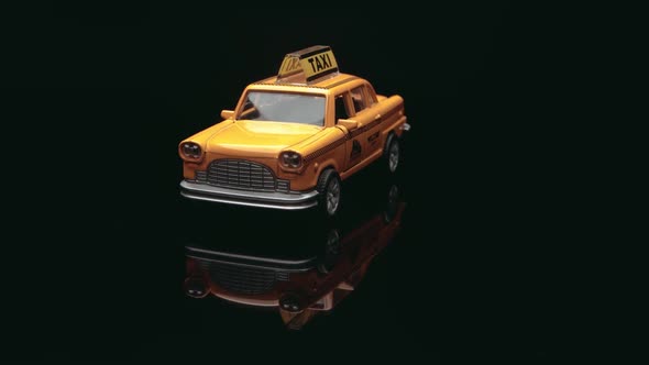 Yellow blank mini taxi toy. Small model of a retro taxi car